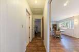 Step into this inviting home and discover a hallway leading to a bright living space.