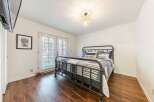 This charming bedroom features a cozy ambiance with its inviting decor and ample natural light.