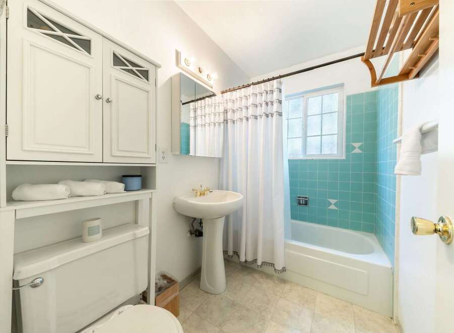 Step into this charming bathroom, featuring a classic design with a touch of vintage flair.