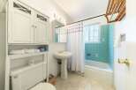 Step into this charming bathroom, featuring a classic design with a touch of vintage flair.