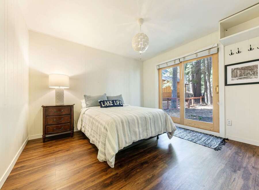 This cozy bedroom offers a serene retreat with its inviting ambiance and natural light.