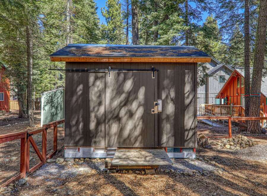 This charming property features a well-maintained shed with a sliding door, perfect for storage or a workshop.