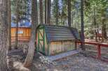 Nestled in a serene wooded setting, this property offers a charming shed with a metal roof, perfect for storage or a workshop.