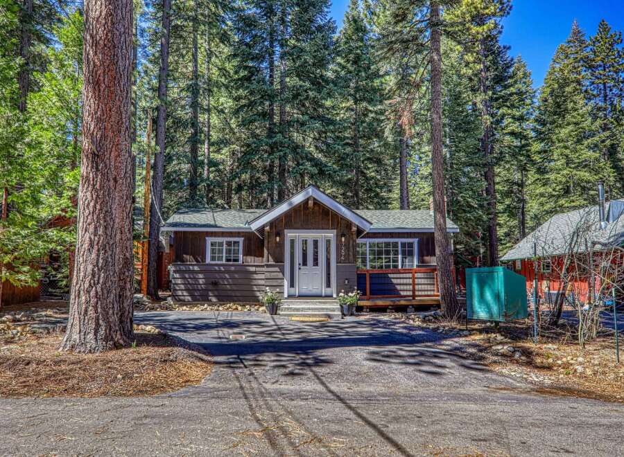 Nestled amidst towering trees, this charming cabin offers a serene escape.