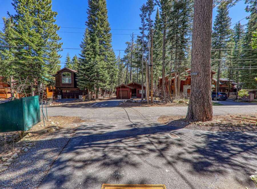 Nestled amidst towering trees, this charming property offers a serene escape.