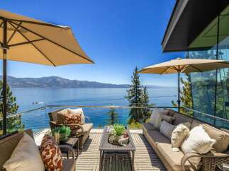 Experience breathtaking lake and mountain views from this stunning modern home's expansive balcony.