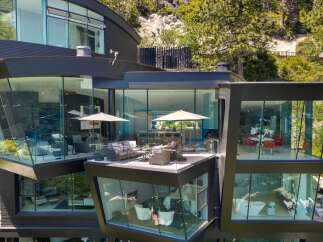 Experience luxury living in this modern architectural marvel, featuring expansive glass walls that seamlessly blend indoor and outdoor spaces.