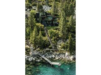 Experience luxury living with this stunning modern home nestled amidst lush trees and overlooking crystal-clear waters.