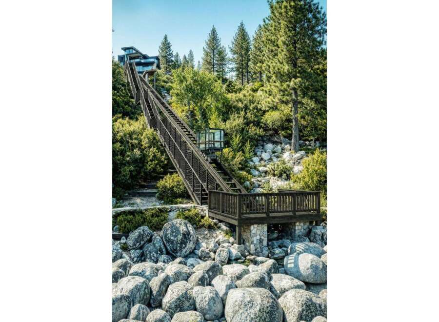 Experience unparalleled lakefront living with this stunning property, featuring a private funicular that ascends to a modern architectural marvel.