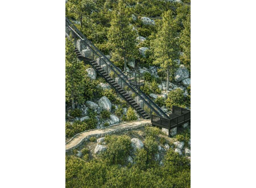 Experience breathtaking views from this unique property featuring a scenic mountain railway and a charming stone-lined pathway.