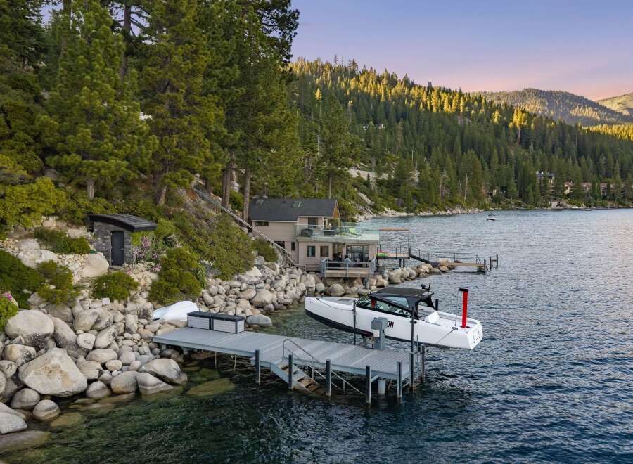Experience luxury lakeside living with this stunning property featuring a private dock and boat lift, perfect for water enthusiasts.