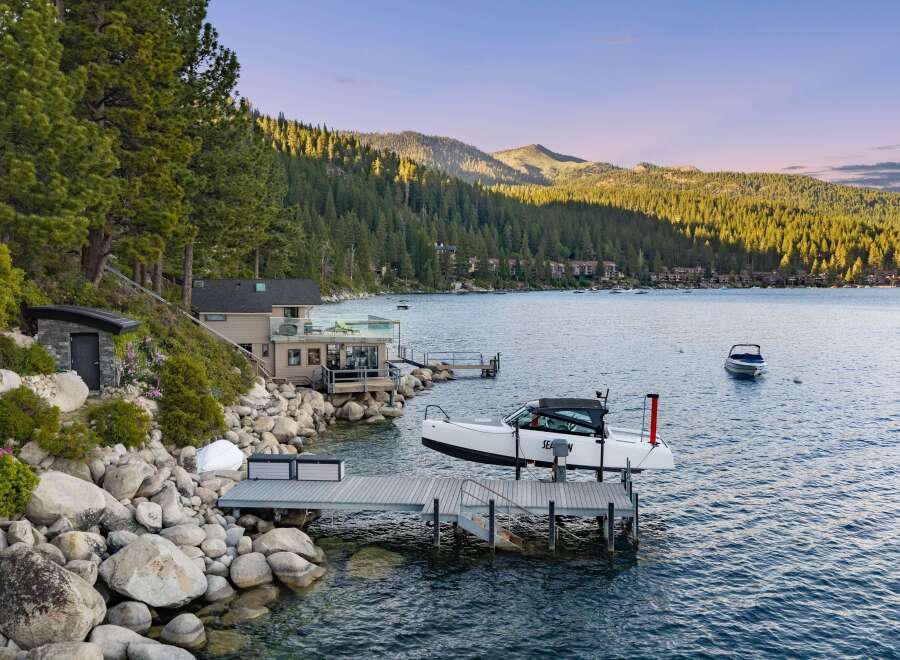 Experience luxury lakeside living with this stunning property featuring a private dock and boat lift, perfect for water enthusiasts.