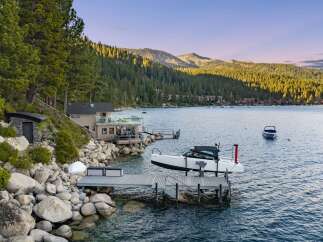 Experience luxury lakeside living with this stunning property featuring a private dock and boat lift, perfect for water enthusiasts.