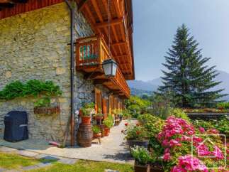 Discover the charm of this stunning property, featuring a beautiful stone facade and a welcoming balcony.