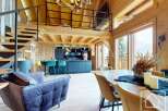 Experience luxury living in this stunning chalet, showcasing exquisite wooden architecture and a modern interior.