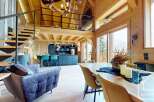 Experience luxury living in this stunning chalet, featuring a modern kitchen with sleek countertops and a cozy living area.