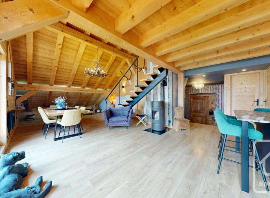 Experience luxury living in this stunning property, featuring a beautifully designed interior with exposed wooden beams and a modern aesthetic.