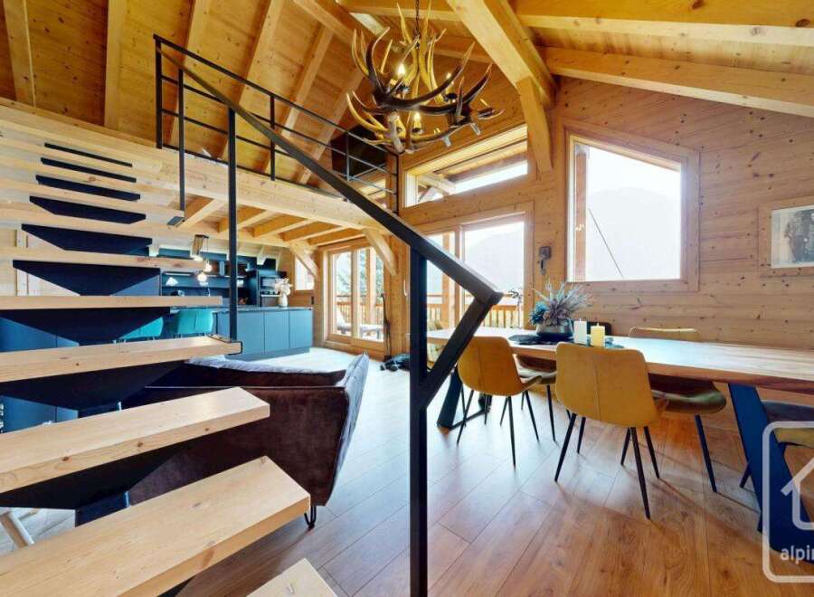 Discover the charm of this stunning property, featuring a modern staircase and a cozy living area.