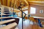 Discover the charm of this stunning property, featuring a modern staircase and a cozy living area.
