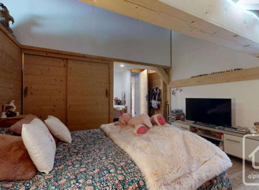 Discover the charm of this cozy bedroom, featuring rustic wooden accents and a comfortable bed.