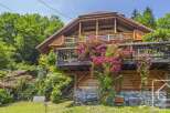 Nestled in a serene natural setting, this charming wooden chalet offers a perfect blend of rustic charm and modern comfort.