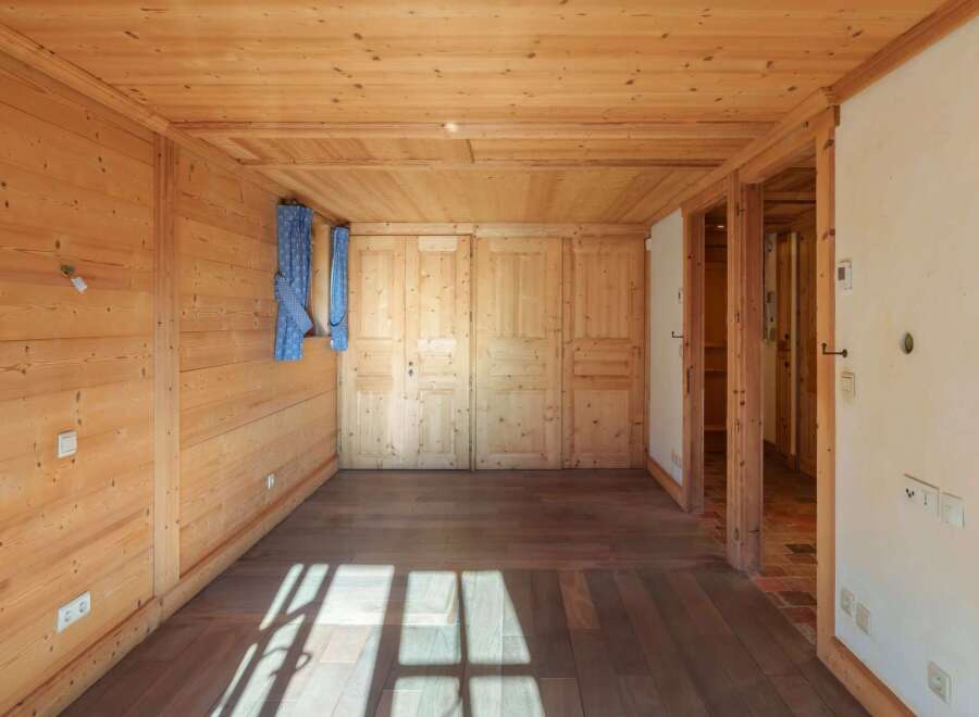 Step into this inviting space, featuring warm wooden walls and flooring that create a cozy atmosphere.