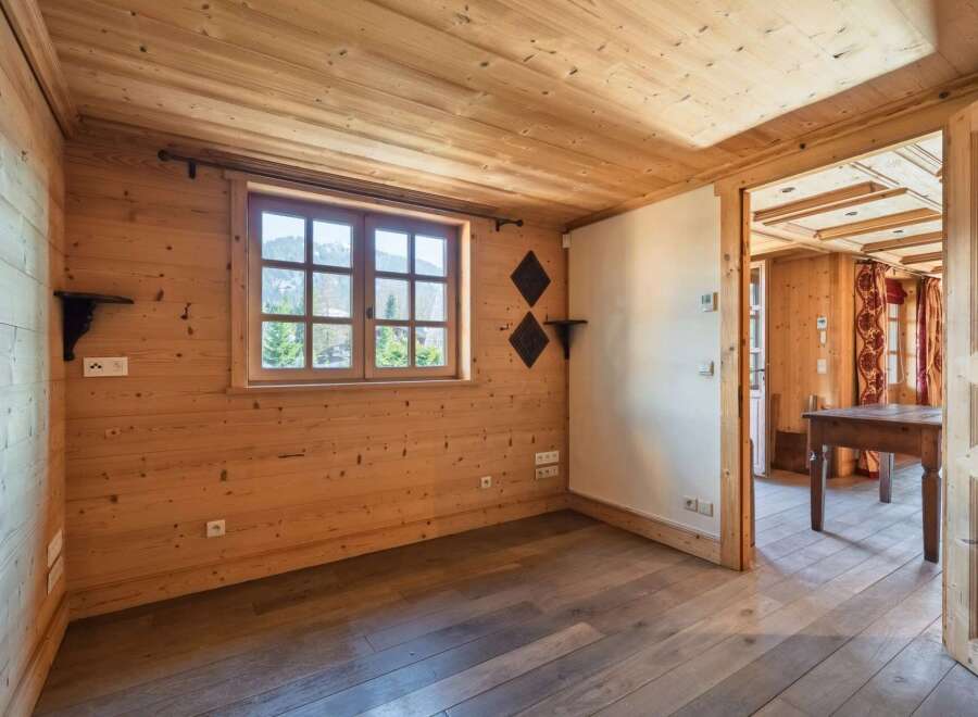 Step into this charming, wood-paneled room, perfect for a cozy retreat.