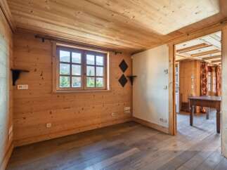 Step into this charming, wood-paneled room, perfect for a cozy retreat.