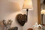 This charming property features a unique heart-shaped wall lamp, adding a touch of rustic elegance.