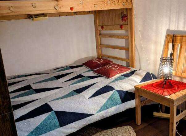 Discover this cozy bedroom featuring a unique bunk bed design, perfect for maximizing space.