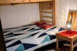Discover this cozy bedroom featuring a unique bunk bed design, perfect for maximizing space.