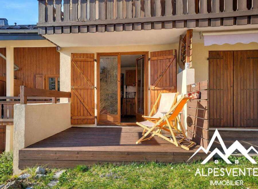 Discover the charm of this stunning property, featuring a beautifully designed wooden deck and inviting outdoor seating.