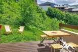 Enjoy the serene mountain views from this charming property's outdoor seating area.