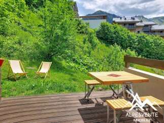 Enjoy the serene mountain views from this charming property's outdoor seating area.