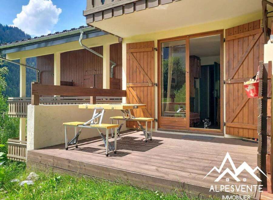 Enjoy outdoor living on this charming wooden deck, perfect for al fresco dining or relaxing with a view.