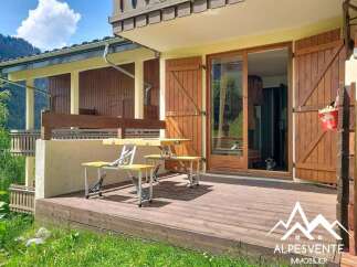 Enjoy outdoor living on this charming wooden deck, perfect for al fresco dining or relaxing with a view.