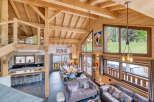 Experience luxury living in this stunning chalet, boasting a spacious open-plan design with exposed wooden beams and high ceilings.
