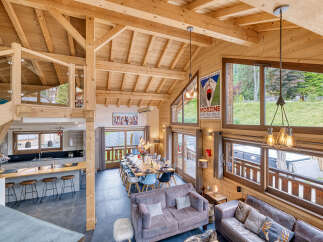 Experience luxury living in this stunning chalet, boasting a spacious open-plan design with exposed wooden beams and high ceilings.