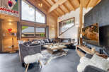 Experience luxury living in this stunning chalet, featuring a spacious living area with a cozy fireplace and a gourmet kitchen.
