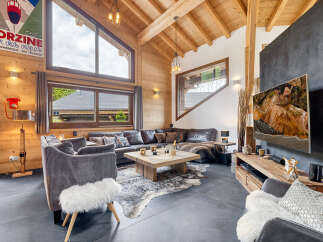 Experience luxury living in this stunning chalet, featuring a spacious living area with a cozy fireplace and a gourmet kitchen.