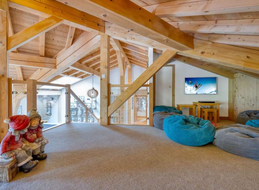 This stunning property boasts a unique architectural design with exposed wooden beams and a cozy, inviting atmosphere.