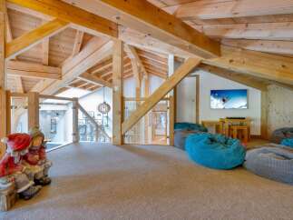 This stunning property boasts a unique architectural design with exposed wooden beams and a cozy, inviting atmosphere.