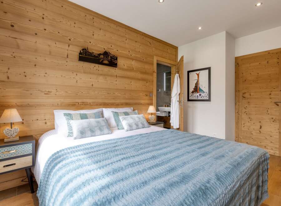 Experience the charm of this cozy bedroom featuring a stunning wooden accent wall.