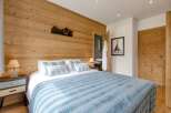Experience the charm of this cozy bedroom featuring a stunning wooden accent wall.