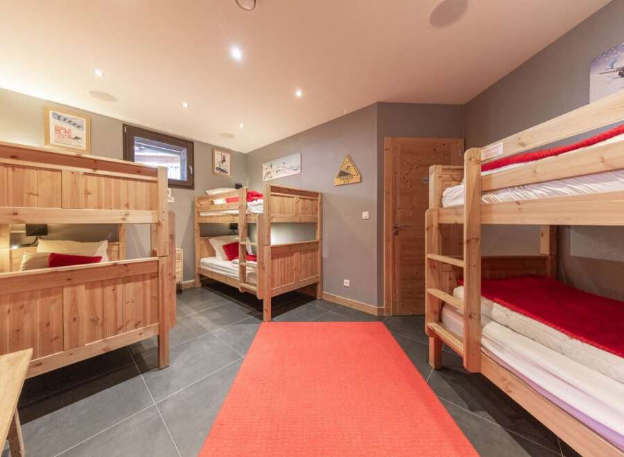 This cozy bedroom features multiple bunk beds, perfect for accommodating a large family or group of friends.