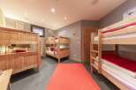 This cozy bedroom features multiple bunk beds, perfect for accommodating a large family or group of friends.
