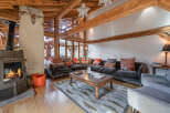 Experience the warmth of this stunning living space, featuring a cozy fireplace and exposed wooden beams that exude rustic charm.