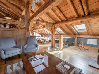 Experience the charm of this stunning property, featuring a beautifully designed interior with exposed wooden beams and a cozy ambiance.