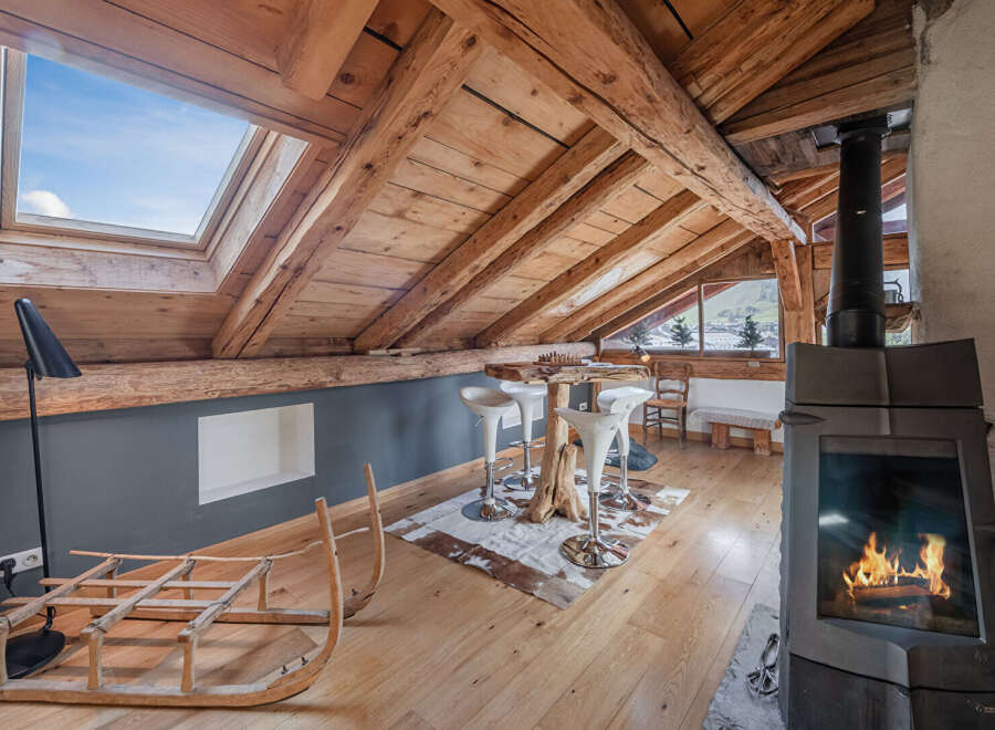 Discover the charm of this unique property, featuring a cozy interior with exposed wooden beams and a skylight that floods the space with natural light.