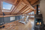 Discover the charm of this unique property, featuring a cozy interior with exposed wooden beams and a skylight that floods the space with natural light.